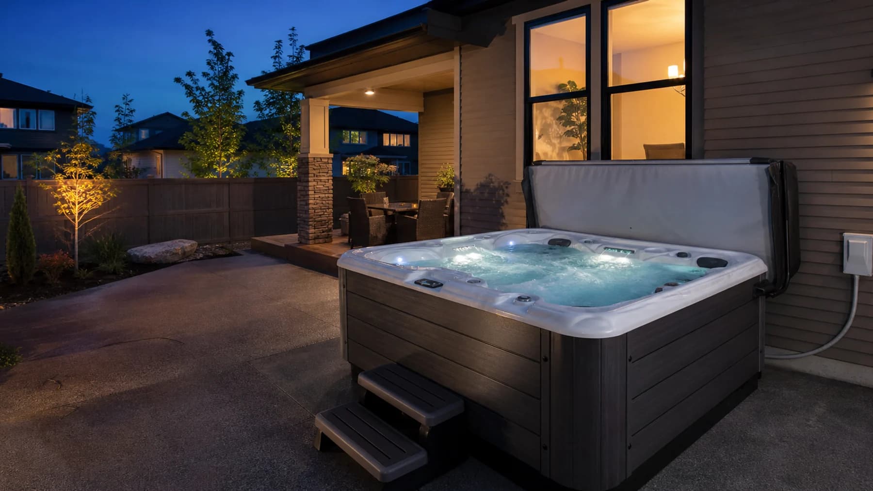 Outdoor hot tub beside a neatly installed weatherproof electrical disconnect at a Calgary Area home